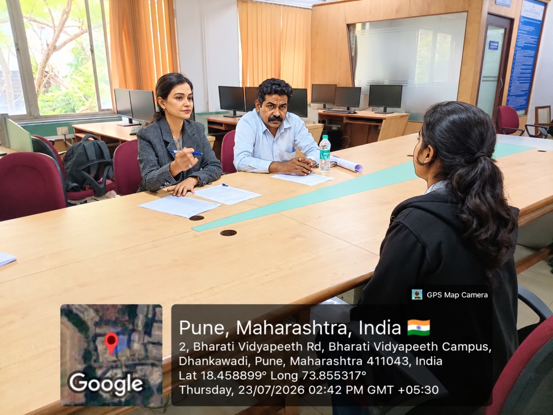 Reviewing a student's project with fellow panelists at Bharati Vidyapeeth's College of Engineering for Women, Pune