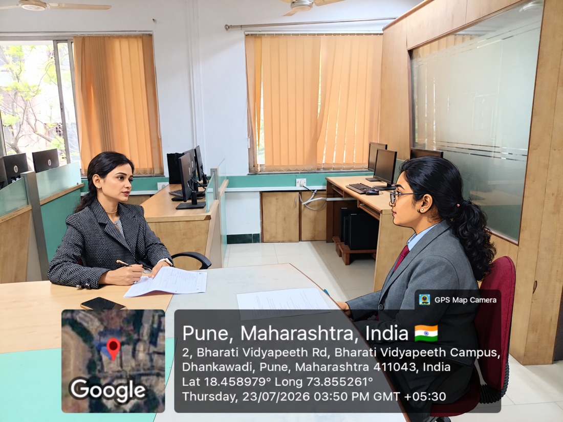 Sitting down for a one-on-one discussion with a student in an office setting